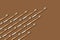 Wedge or arrow shaped bamboo toothbrushes on brown background