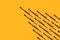 Wedge or arrow shaped bamboo toothbrushes on yellow background