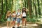 Weekend activies. Kids strolling in the forest with travel equipment