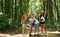 Weekend activies. Kids strolling in the forest with travel equipment