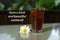 Weekend inspirational quote - Have a fresh and beautiful weekend. A glass of tea with ice and flower on white tabke.