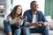 Weekend Leisure. Joyful Mixed Couple Playing Video Games In Living Room