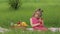 Weekend at picnic. Girl on grass meadow play online games on mobile phone. Social network, chatting