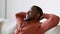 Weekend relaxation. Close up portrait of young carefree african american man resting on sofa, free space