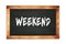 WEEKEND text written on wooden frame school blackboard