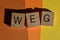 WEG, acronym in wooden alphabet letters isolated on colourful background