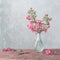 weigela flowers in vase on wooden table