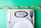 Weighing scale plate fork knife centimeter on green background