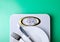 Weighing scale plate fork knife centimeter on green background