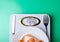 Weighing scale plate fork knife centimeter on green background