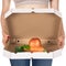 Weight loss and healthy eating or dieting concept. Slim girl with open pizza box and raw vegetables in it.