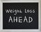 Weight Loss Sign on Black Chalk Board