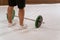 Weightlifting young man taking a brake standing near black and green weight set, equipment for weight training concept