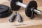 Weights and dumbbell set for fitness on a wooden background