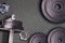 Weights at the gym whit handle and barbell. Stel gym equipment on metal floor background.