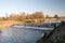 Weir on Olse river in Karvina city in Czech republic with trees on the background