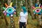 Weird young adult woman with dyed turquoise hair in white T shirt near big eyes art installation