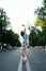 Weird young woman stretching in the middle of an empty city road. Low angle.