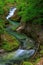 Weissbachschlucht a gorge with a blue mountain stream and many waterfalls forest a hiking trail plants and rocks