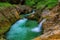 Weissbachschlucht a gorge with a blue mountain stream and many waterfalls forest a hiking trail plants and rocks