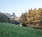 Weisse Elster river with meadow, colorful autumn trees and blue sky near Plauen