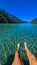 Weissensee - Close up on legs of man, lying at the east shore of Weissensee lake in Carinthia