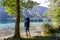 Weissensee - Man with baby carrier looking at scenic view of east bank of alpine lake Weissensee
