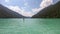 Weissensee - A man stand up paddling through the crystal clear lake