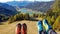 Weissensee - Two pairs of hiking shoes on the slope with the view on a distant lake