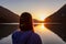 Weissensee - Woman enjoying allure of sunset at alpine lake Weissensee in remote Austrian Alps in Carinthia