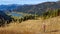 Weissensee - A woman standing on a slope and enjoying the view on the distant lake