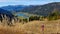 Weissensee - A woman standing on a slope and enjoying the view on the distant lake