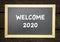 Welcome 2020, text on black board