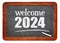 Welcome 2024 - New Year concept on a vintage slate blackboard