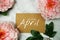 Welcome April typography text with peony flowers on marble background