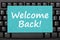 Welcome Back message on a greeting card on black keyboard