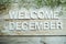 Welcome December alphabet letters on wooden background