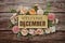 Welcome December text on wooden board with flowers frame on wooden background