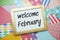 Welcome February text on colorful background