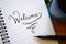 WELCOME hand-lettered in notebook