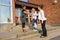 Welcome handshake between schoolgirl mother and teacher