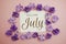Welcome July card typography text with flower bouquet on pink background