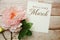 Welcome March card typography text with flower bouquet on wooden background