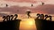 Welcome Merry Christmas and Happy New Year in 2023, Vector black silhouette man jumping from 2022 cliff to 2023 cliff with cloudy