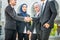 Welcome onboard! Muslim Asian business people shake hands