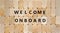 Welcome onboard and support symbol. Concept words Welcome onboard on wooden blocks on a beautiful wooden background, copy space.