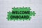 Welcome onboard symbol. Concept words Welcome onboard on white puzzle. Beautiful green background. Business and Welcome onboard