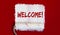 WELCOME .One open can of paint with white brush on red background. Top view