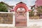 Welcome pink gate, pink fence white walls, stone wall.  A house in the village