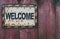 Welcome plaque on a fence